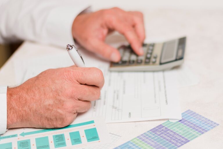 Documentos y formulario de impuestos sobre una mesa, representando el trámite de alivio fiscal.